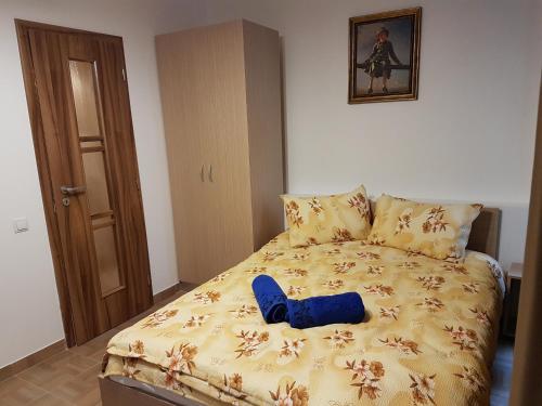 a bedroom with a bed with a blue shoe on it at Casa Rezidentiala Aria in Cluj-Napoca