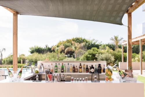 a bar with a lot of bottles of alcohol at Eurostars Cascais in Cascais