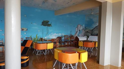 a dining room with a fish mural on the wall at Hotel Ocean View & Restaurante Seafood in São Filipe