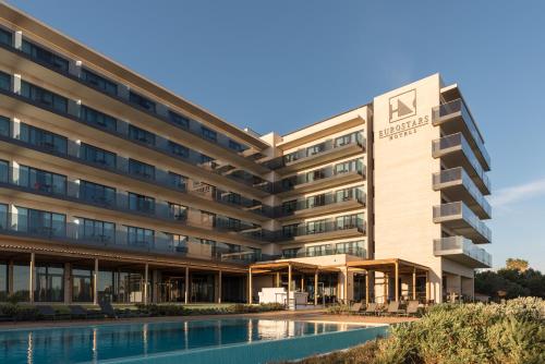 an office building with a swimming pool in front of it at Eurostars Cascais in Cascais