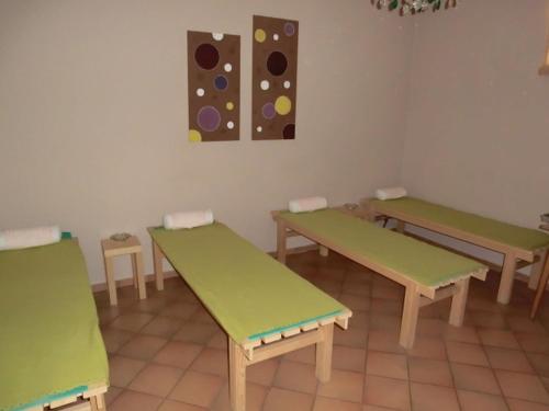 a room with green benches and paintings on the wall at Hotel-Restaurant Kreuzhuber in Neuburg am Inn