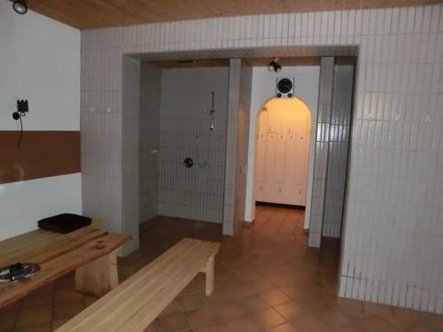an empty room with a bench and a pink door at Hotel-Restaurant Kreuzhuber in Neuburg am Inn