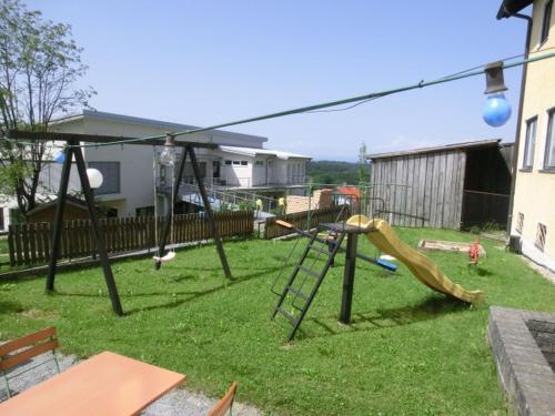 a playground with a slide in a yard at Hotel-Restaurant Kreuzhuber in Neuburg am Inn