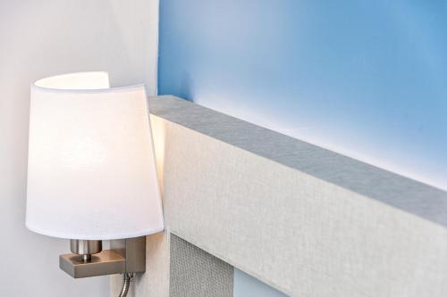a lamp on a wall next to a ledge at Veramar Aparthotel in Fuengirola