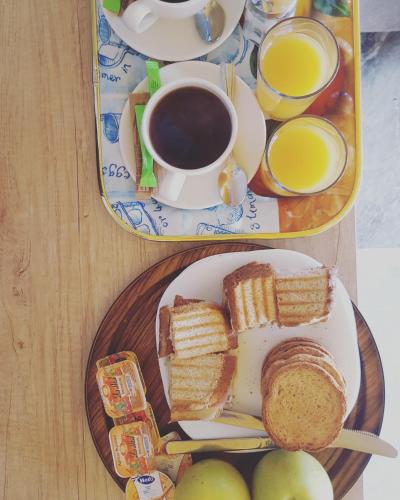 two plates of food with sandwiches and a cup of coffee at Varmy in Ierápetra