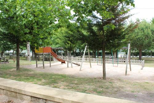 a park with a playground with a slide and trees at Hotel Medieval® de Penedono in Penedono