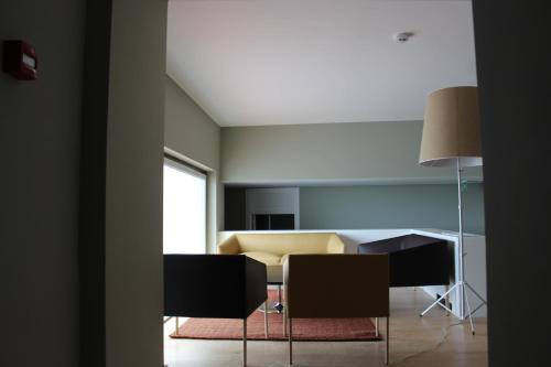 a living room with a couch and a table and chairs at Hotel Medieval® de Penedono in Penedono