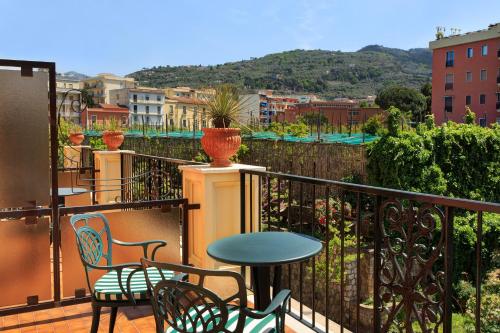 a balcony with chairs and a table and a view at Grand Hotel Royal in Sorrento