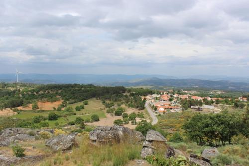 a view of a town on a hill with rocks at Hotel Medieval® de Penedono in Penedono