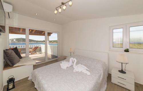 a bedroom with a bed with two swans on it at Luxury villa Vela Rina in Mali Drvenik