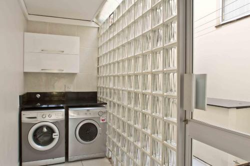 a laundry room with a washer and dryer next to a wall at D3 Sea Lodge - by Stay in Umhlanga in Durban