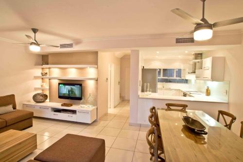 a living room with a dining table and a kitchen at D3 Sea Lodge - by Stay in Umhlanga in Durban