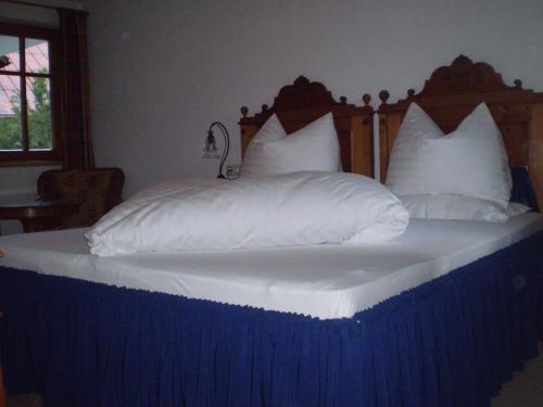a bed with white sheets and pillows on it at Villa 17 in Gaschurn