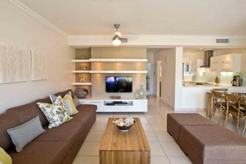 a living room with a couch and a table at D3 Sea Lodge - by Stay in Umhlanga in Durban