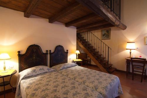 a bedroom with a large bed and a staircase at Agriturismo La Cascinetta in Pieve di Cento
