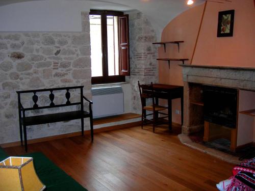 a living room with a fireplace and a window at Bed and Breakfast Via Della Piazza in Pescasseroli