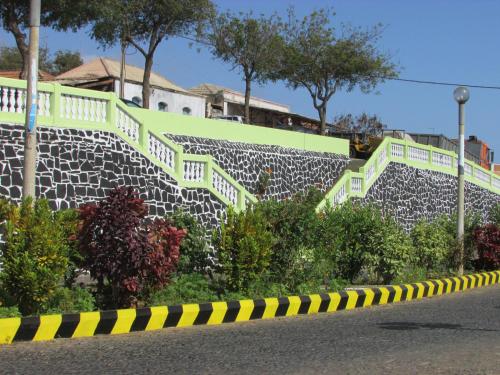 a yellow and black caution tape next to a retaining wall at Hotel Ocean View & Restaurante Seafood in São Filipe