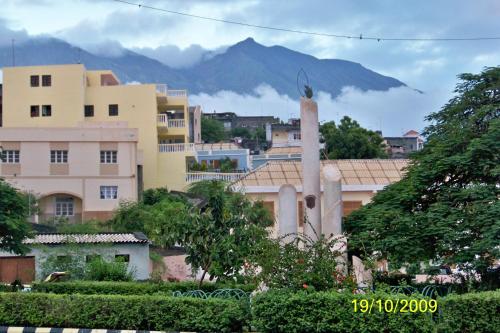 a building with a bird on top of it in a city at Hotel Ocean View & Restaurante Seafood in São Filipe