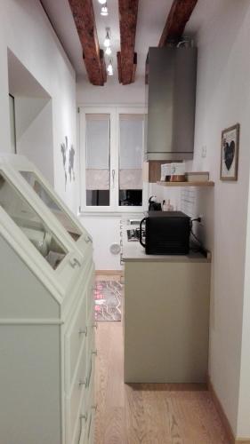 a kitchen with white cabinets and a counter top at homesweethome venice in Venice