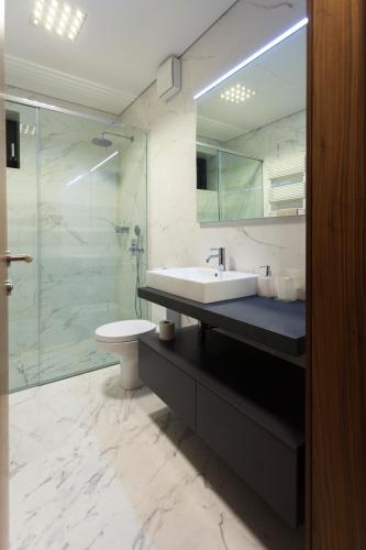 a bathroom with a sink and a glass shower at Villa EVA in Dobrovo