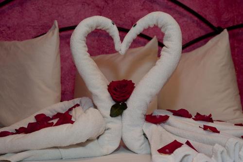 a bed with two swans made out of towels at Hacienda Maria Bonita Hotel in Playa del Carmen
