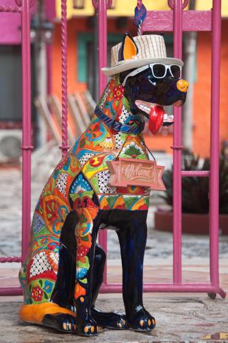a statue of a dog wearing a hat and sunglasses at Hacienda Maria Bonita Hotel in Playa del Carmen