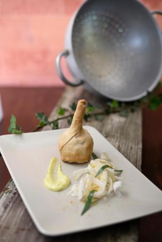 a white plate with a mushroom on a table at Agriturismo Ponterosa in Morrovalle