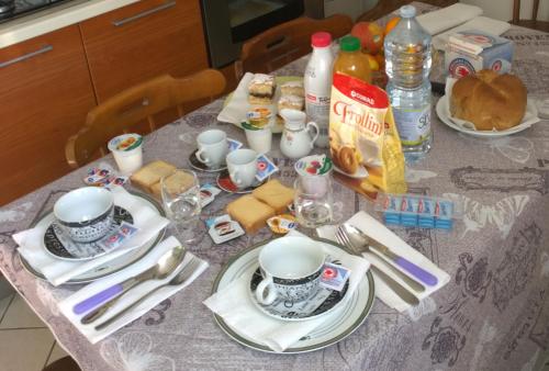 a table with a table cloth with a tea set on it at Borgo Foce La Spezia in La Foce