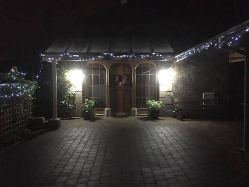 a house with lights on the front of it at night at Crotlieve Barn in Rostrevor