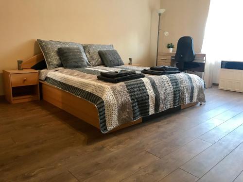 a bedroom with a bed and a wooden floor at Great Home in Pécs