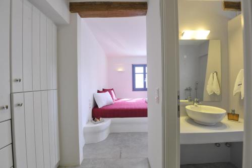 a bathroom with a sink and a toilet in a room at Alexandros Studios in Naousa