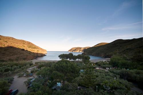 a view of a body of water between two hills at Hotel Cala Joncols in Roses