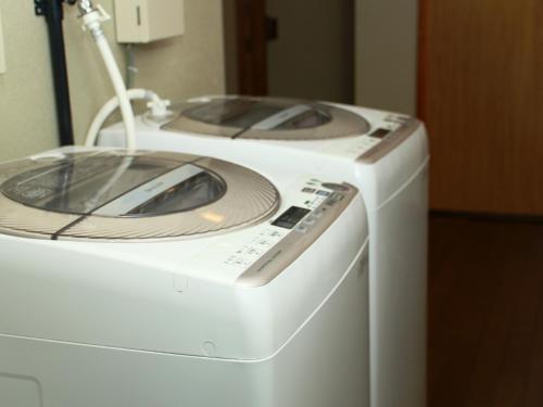 two washing machines are sitting next to each other at Marumo Ryokan in Takashima