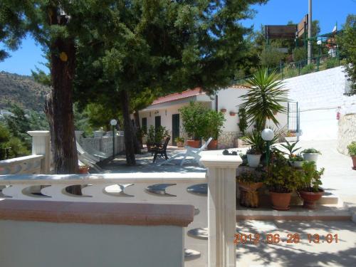 a garden with a fence and trees and plants at Pensione San Michele in Mattinata