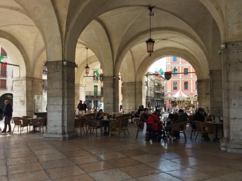 a group of people sitting at tables in a building at La Loggia Al Duomo - Treviso in Treviso