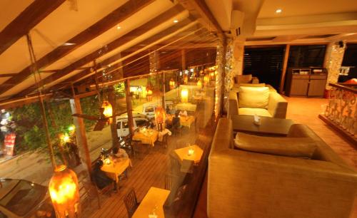 a large living room with couches and tables at De Baga Deck Comforts in Calangute