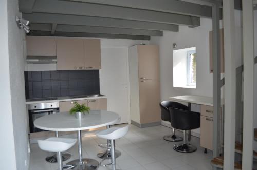 a kitchen with a table and chairs in a room at Maison Coetquen in Saint Malo
