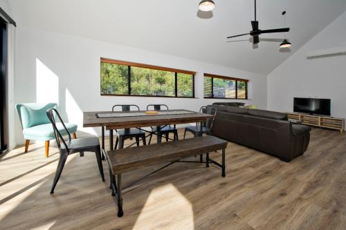 a living room with a table and a couch at Margaret River Bungalow-1-street - pet friendly in Margaret River Town