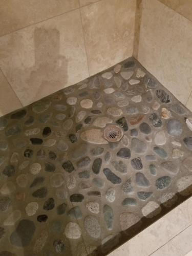 a shower floor with rocks and stones on it at Rustic Elegance in Talkeetna