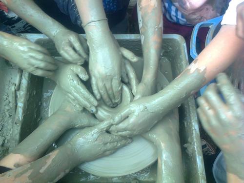 a group of people putting their hands on a plate at B&B Terre e Colori in Sant'Olcese
