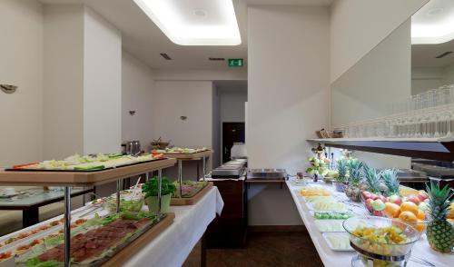 a buffet line with many different types of food at Hotel Aurora in Wiesbaden