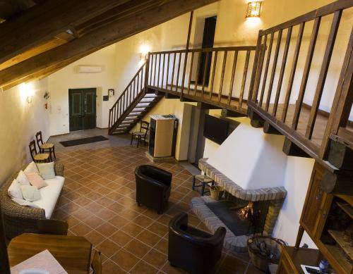 an overhead view of a living room with couches and a staircase at B&B Charme Sa Pardina in Orroli