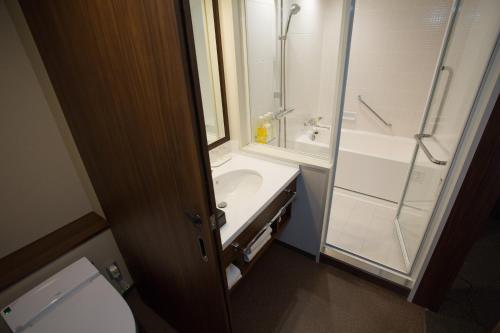 a bathroom with a toilet and a sink and a shower at Nagoya Tokyu Hotel in Nagoya