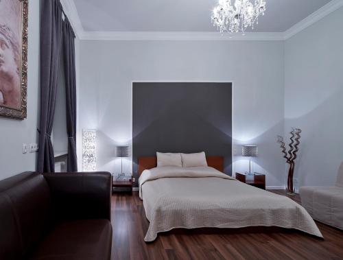 a bedroom with a bed and a couch at Hotel Aurora in Wiesbaden