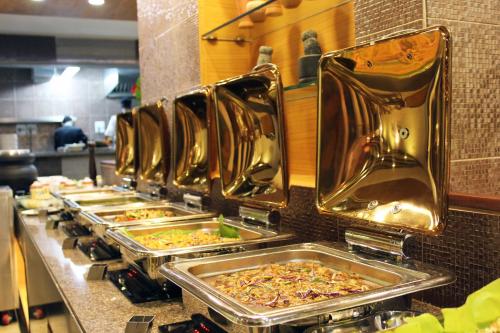 a row of trays of food in a kitchen at Sterling Yercaud in Yercaud