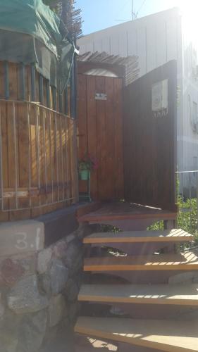 a set of wooden stairs next to a building at Casa Rosa in Eilat