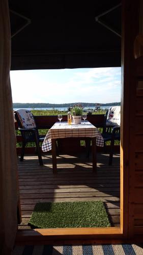 a table and chairs on a deck with a view at Muskö Havsbad in Muskö Havsbad
