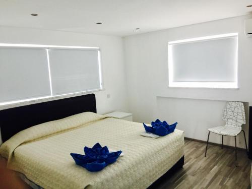 a bedroom with a bed with blue flowers on it at Royal Sugar in Ayia Napa