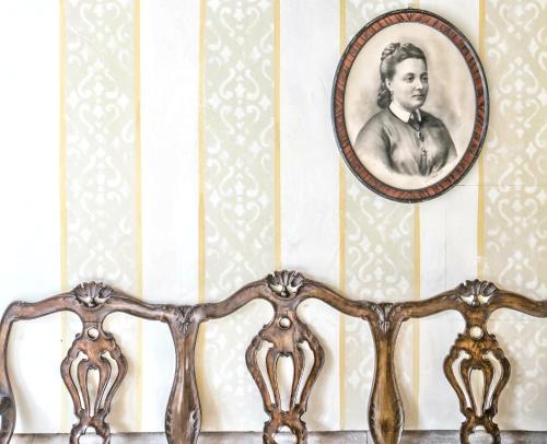 a wooden bench with a mirror on a wall at Hotel Palazzo Vitturi in Venice
