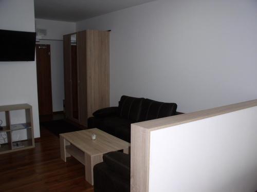 a living room with a couch and a coffee table at Apartmán Cyril A 104 in Smokovce